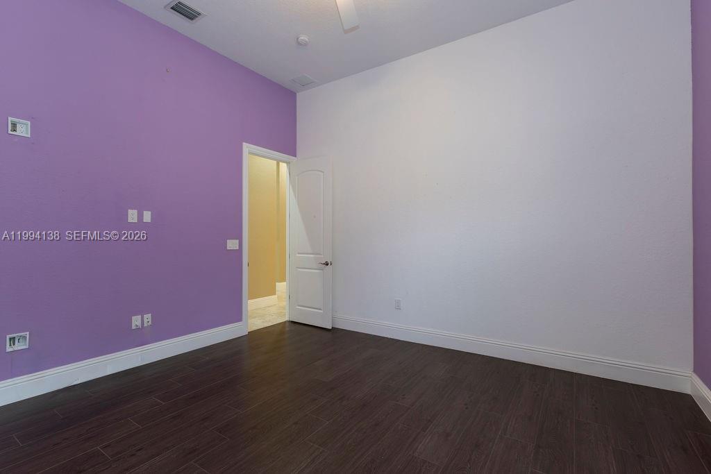 4800 Southwest 141st Avenue Miramar, FL 33027 - Photo 45 of 90 an empty room with wooden floor and a window