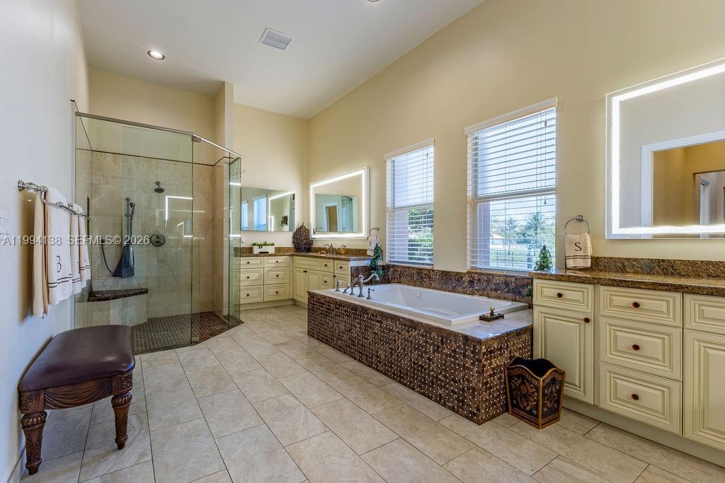 4800 Southwest 141st Avenue Miramar, FL 33027 - Photo 58 of 90 a large spacious bathroom with a granite countertop tub shower and mirror
