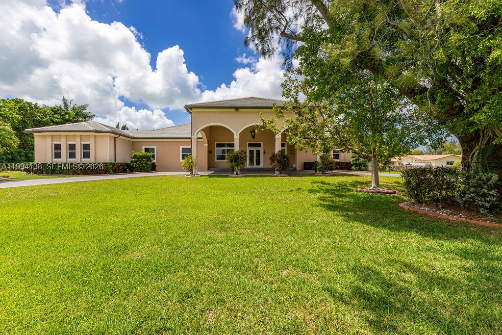 4800 Southwest 141st Avenue Miramar, FL 33027 - Photo 67 of 90 a view of a house with a big yard and large trees