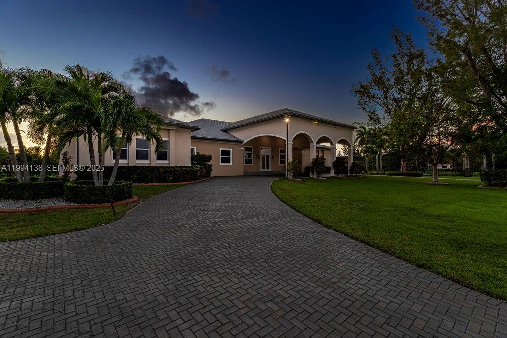 4800 Southwest 141st Avenue Miramar, FL 33027 - Photo 83 of 90 a front view of a house with a yard and green space