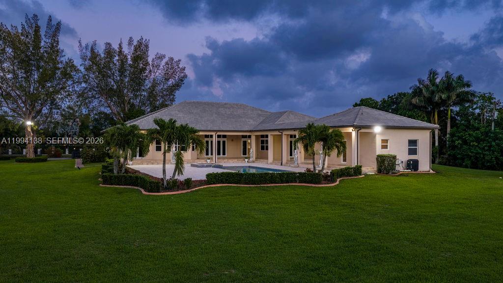 4800 Southwest 141st Avenue Miramar, FL 33027 - Photo 87 of 90 a front view of a house with a garden and trees