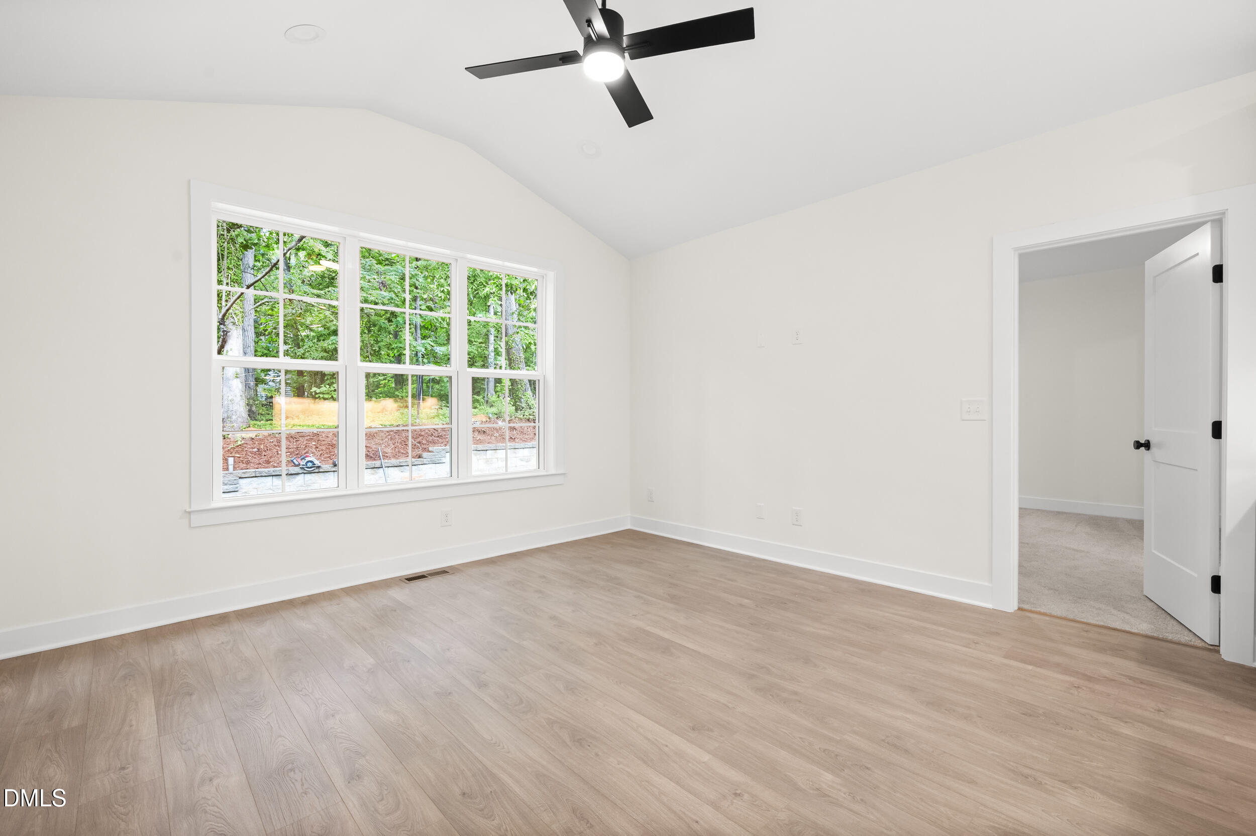 708 Grayhaven Place Raleigh, NC 27606 - Photo 12 of 33 an empty room with a window and a ceiling fan