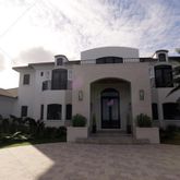 a front view of a house with plants