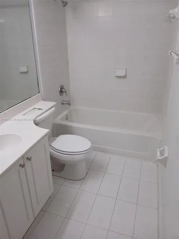 a bathroom with a toilet a sink and bathtub