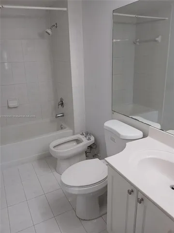 a white toilet sitting next to a bath tub
