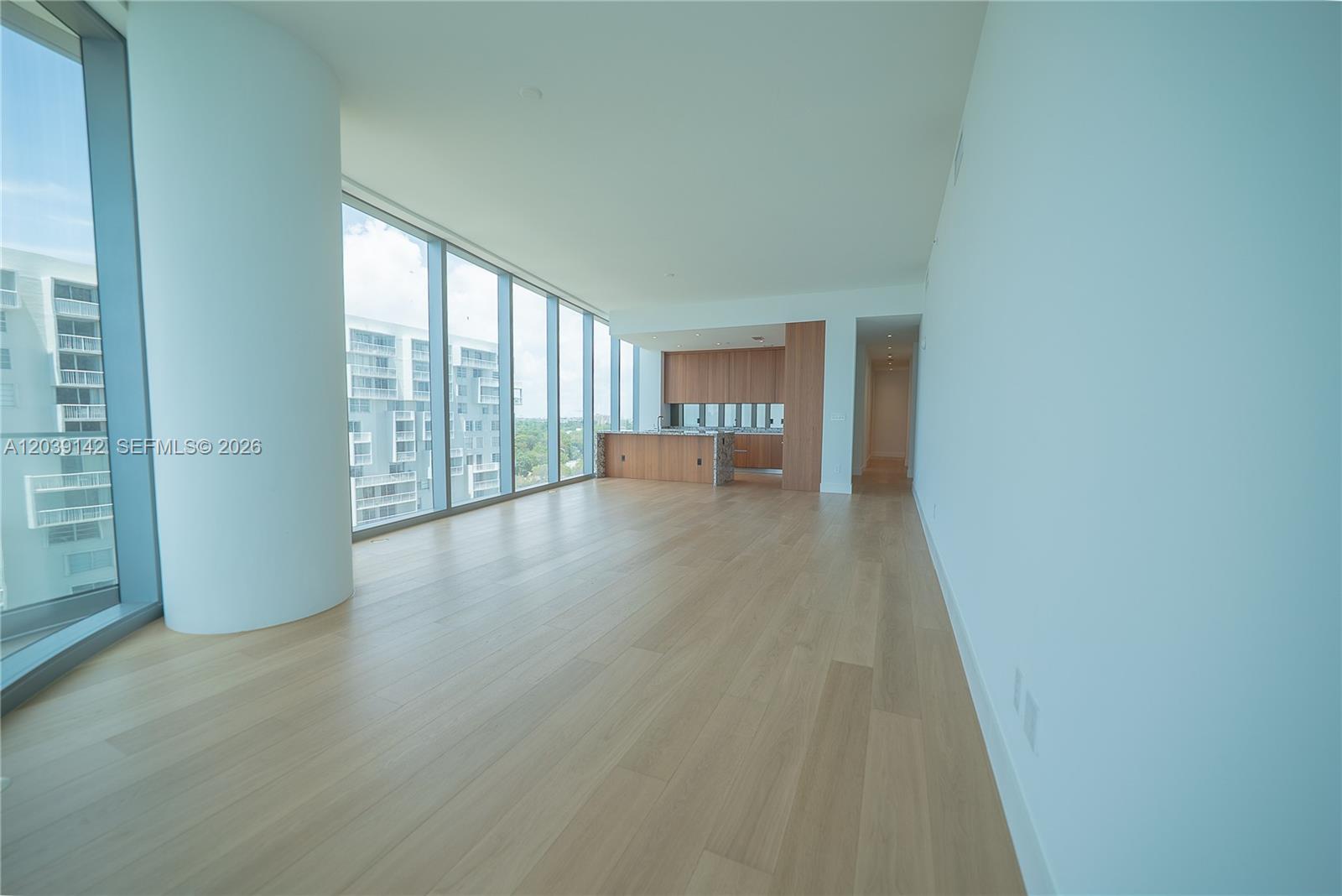 175 Southeast 25th Road, Unit 702 Miami, FL 33129 - Photo 3 of 30 an empty room with wooden floor and windows