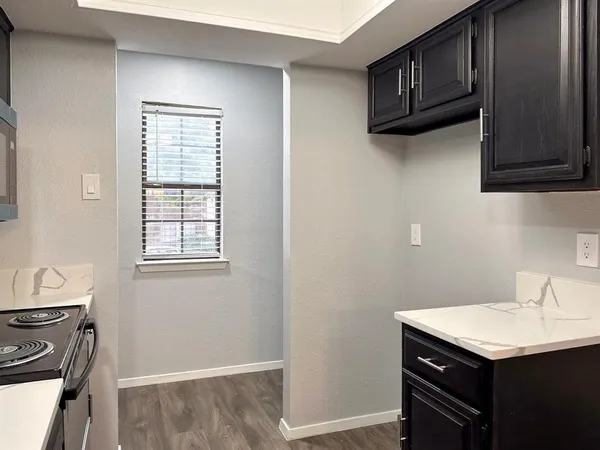 a kitchen with a sink cabinets and a window