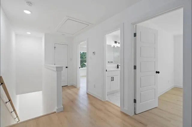 a view of a hallway with wooden floor