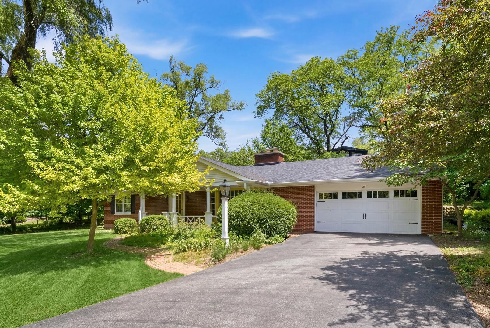 a front view of a house with a yard and a garage