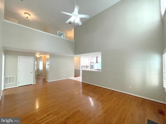 a kitchen with a sink and chairs