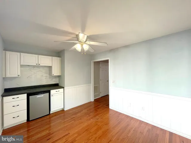 a kitchen with a sink counter top space appliances and a center island