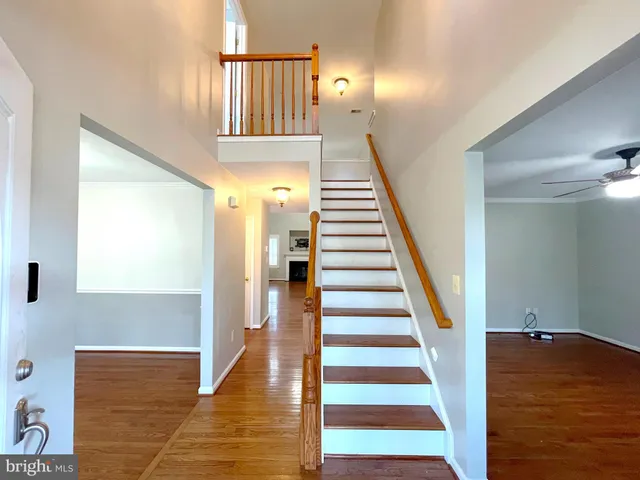a view of a hallway with wooden floor and entryway