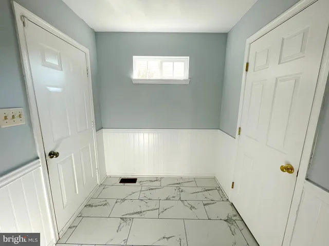an empty room with a ceiling fan and a window