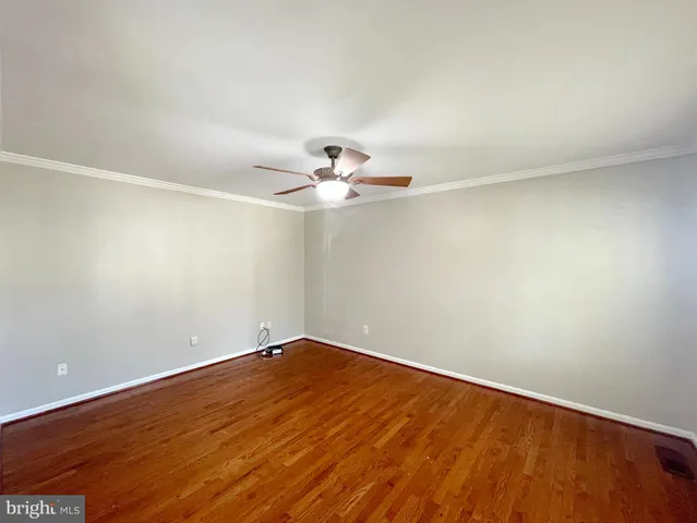 a view of an empty room with a kitchen and fireplace