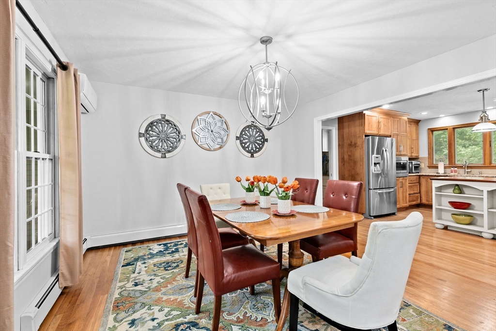 21 Chowdermarch Street Marshfield, MA 02050 - Photo 16 of 39 a view of a dining room with furniture wooden floor and a chandelier
