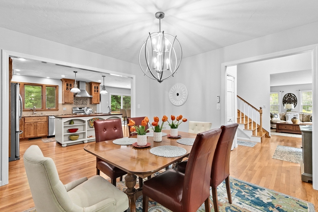 21 Chowdermarch Street Marshfield, MA 02050 - Photo 18 of 39 a view of a dining room with furniture a chandelier and wooden floor