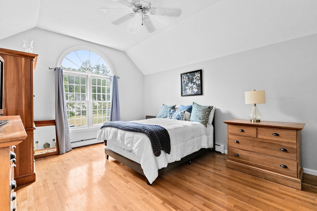 21 Chowdermarch Street Marshfield, MA 02050 - Photo 20 of 39 a spacious bedroom with a bed and a chandelier