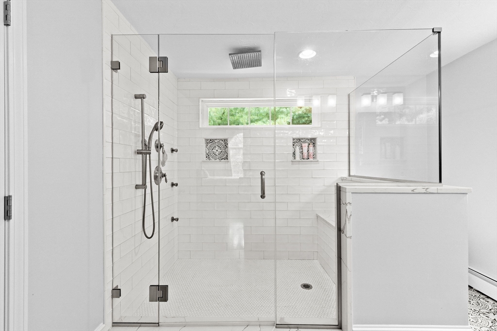 21 Chowdermarch Street Marshfield, MA 02050 - Photo 23 of 39 a bathroom with a glass shower door and a window