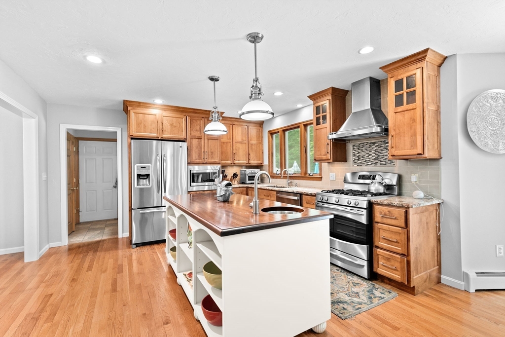 21 Chowdermarch Street Marshfield, MA 02050 - Photo 4 of 39 a kitchen with stainless steel appliances granite countertop a sink stove and refrigerator