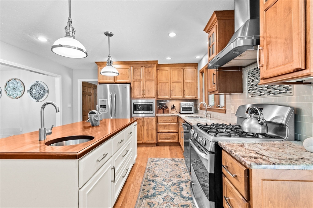 21 Chowdermarch Street Marshfield, MA 02050 - Photo 5 of 39 a kitchen with stainless steel appliances granite countertop a sink stove and cabinets
