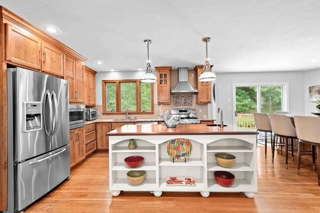 21 Chowdermarch Street Marshfield, MA 02050 - Photo 6 of 39 a kitchen with stainless steel appliances granite countertop a sink a stove a refrigerator and island with wooden floor