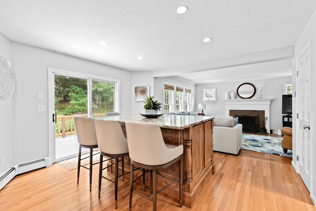 21 Chowdermarch Street Marshfield, MA 02050 - Photo 8 of 39 a dining room with furniture a fireplace and wooden floor