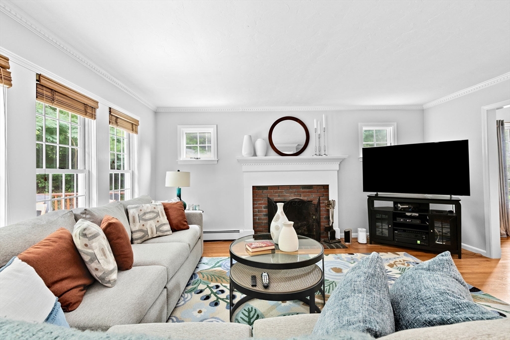 21 Chowdermarch Street Marshfield, MA 02050 - Photo 9 of 39 a living room with furniture a fireplace and a flat screen tv