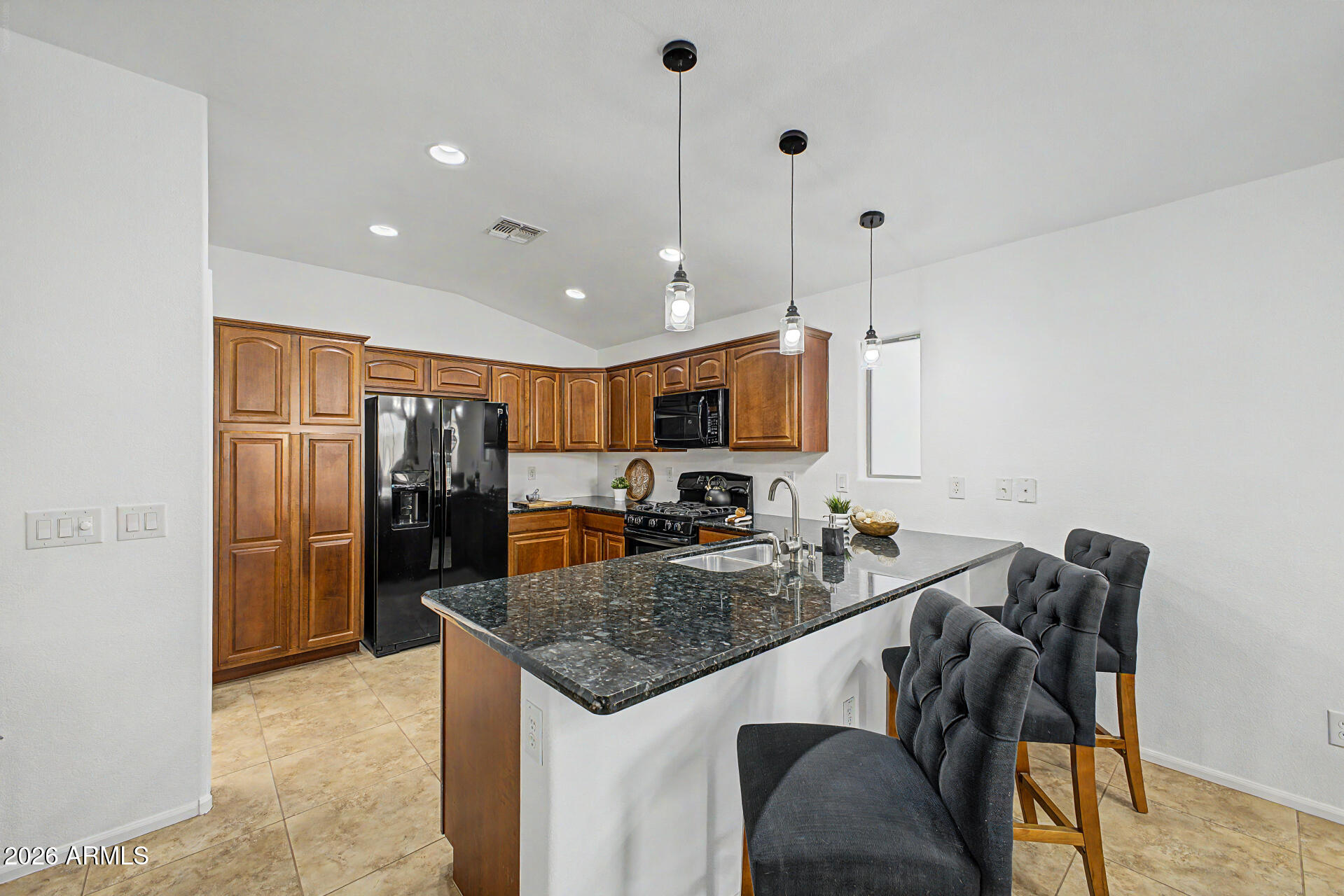 4168 East Sandy Way Gilbert, AZ 85297 - Photo 9 of 47 a kitchen with stainless steel appliances granite countertop a sink refrigerator and cabinets