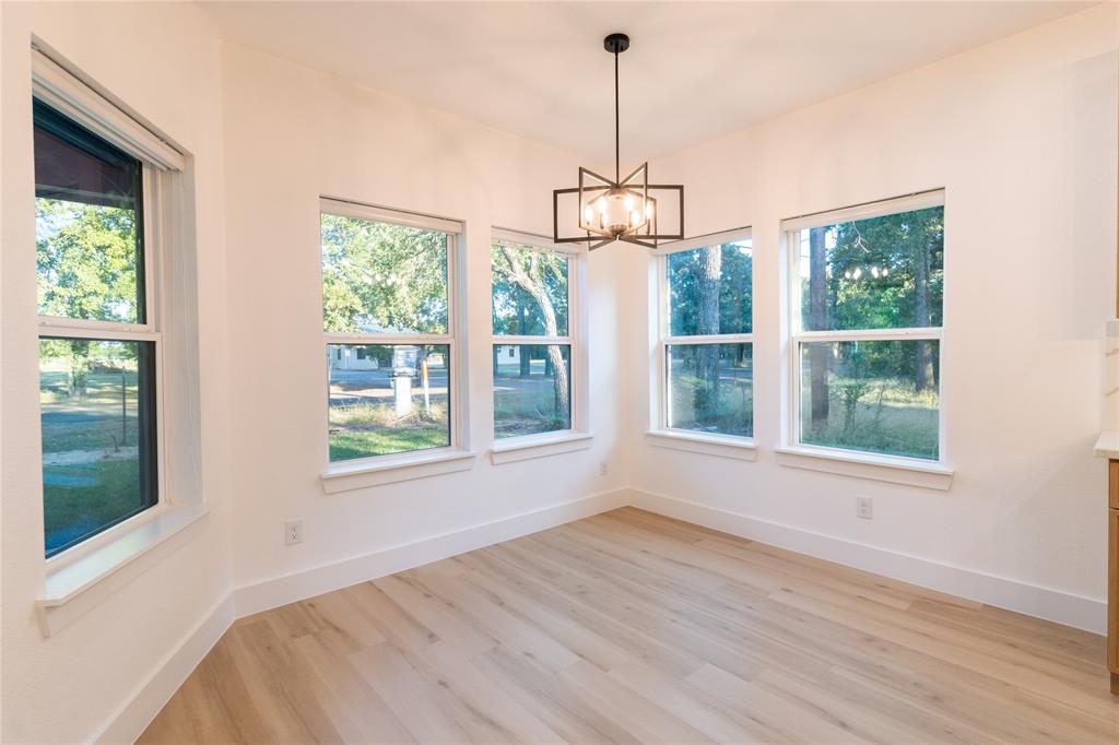 6131 Inca Drive Mabank, TX 75156 - Photo 6 of 21 a view of empty room with wooden floor and windows