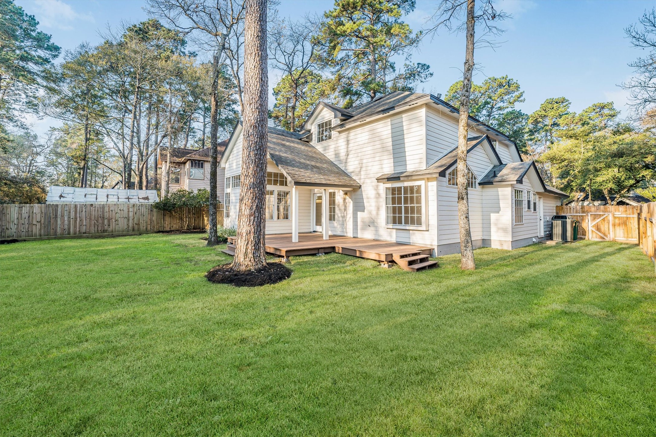 235 South Crimson Clover Circle Spring, TX 77381 - Photo 3 of 22 a white house that has a small yard and large trees