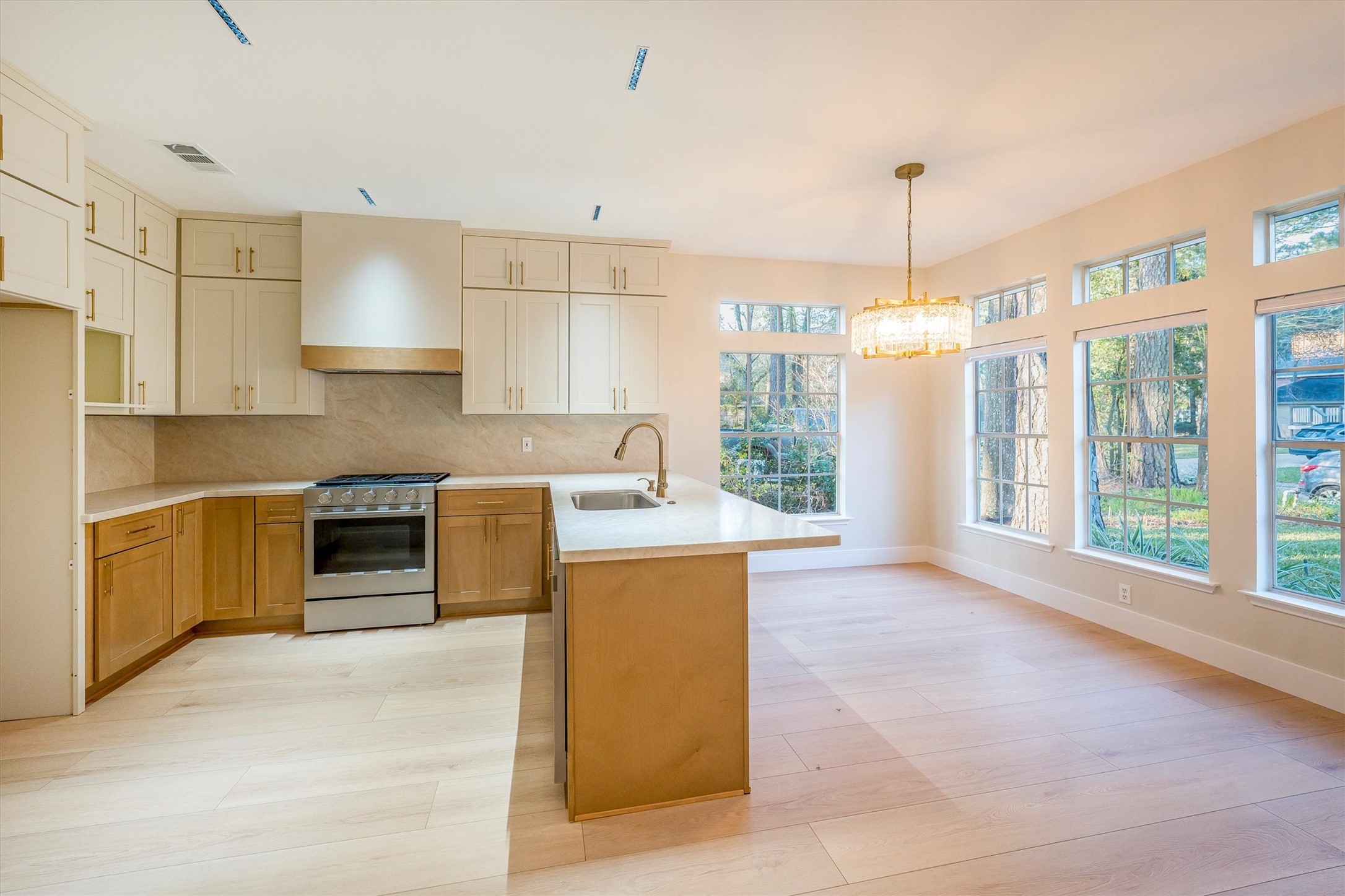 235 South Crimson Clover Circle Spring, TX 77381 - Photo 5 of 22 a kitchen with a stove a refrigerator a sink and dishwasher with wooden floor