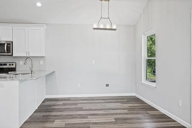 a view of kitchen and sink with wooden floor