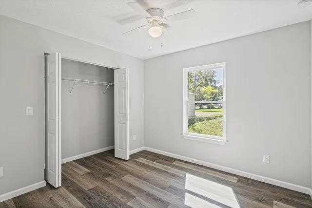 an empty room with windows and closet