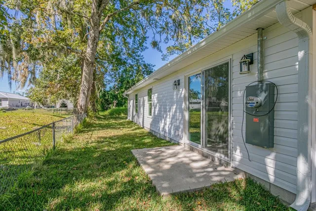 a view of a house with backyard and porch