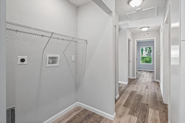 a view of a room with wooden floor