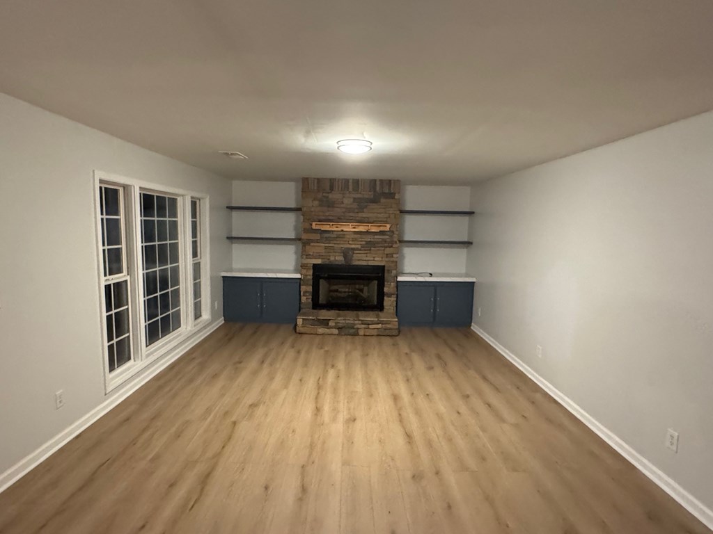 950 Ballewtown Road Blue Ridge, GA 30513 - Photo 9 of 12 a view of an empty room with a fireplace and wooden floor