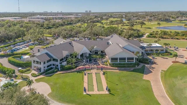 an aerial view of residential houses with outdoor space and swimming pool