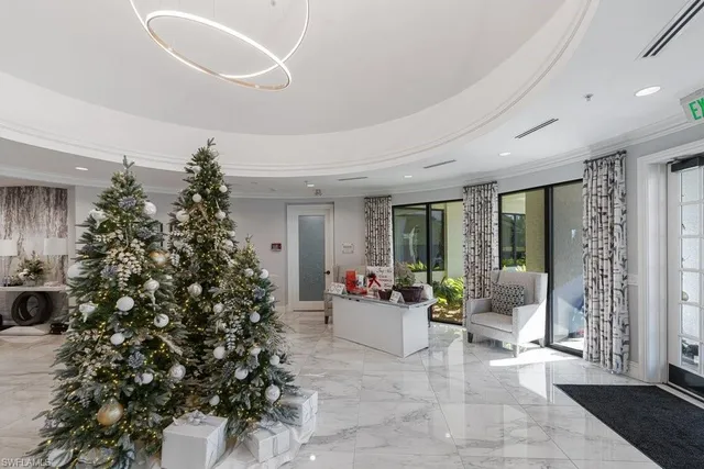 a living room with a large window and potted plants