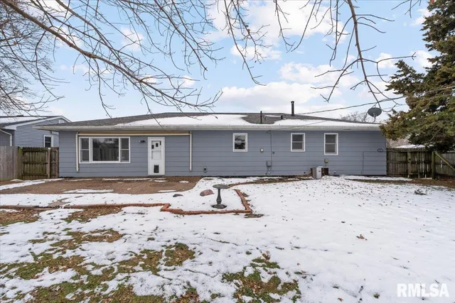 a front view of a house with a dirt yard