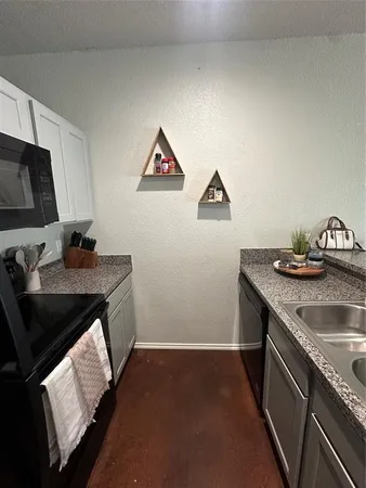 a kitchen that has a sink and a stove