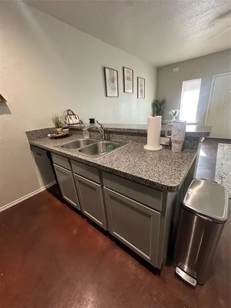 a kitchen with stainless steel appliances granite countertop a sink stove and cabinets