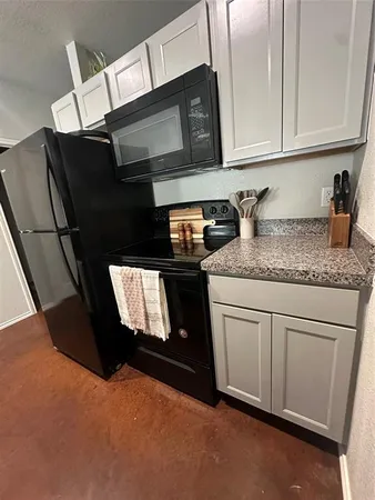 a kitchen with granite countertop cabinets stainless steel appliances and a sink