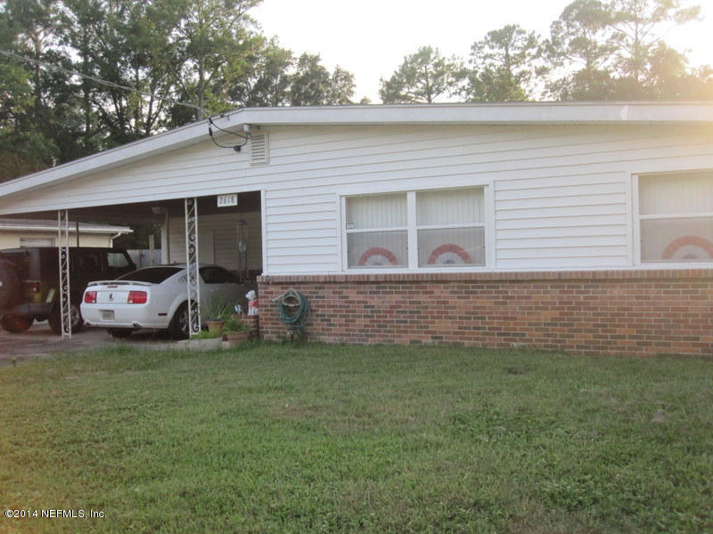 2618 Sam Road Jacksonville, FL 32216 - Photo 1 of 16 a couple of cars parked in front of a house