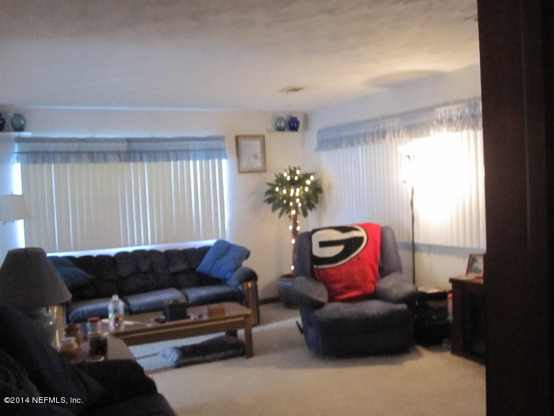 2618 Sam Road Jacksonville, FL 32216 - Photo 13 of 16 a living room with furniture and flowers