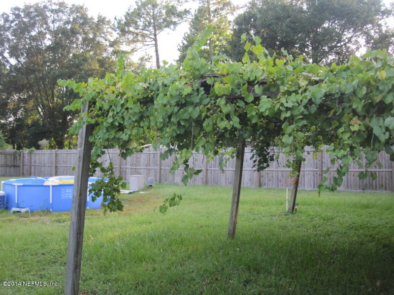 2618 Sam Road Jacksonville, FL 32216 - Photo 16 of 16 a backyard of a house with lots of green space