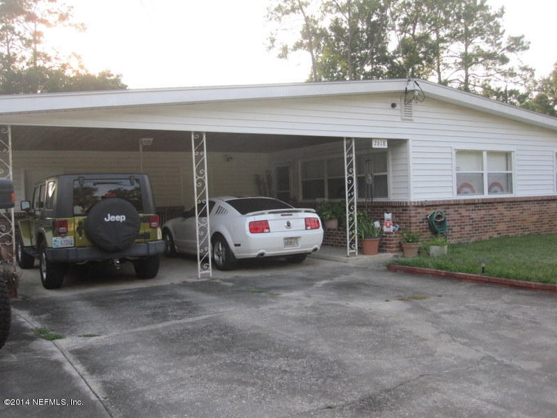 2618 Sam Road Jacksonville, FL 32216 - Photo 2 of 16 a car parked in front of white house