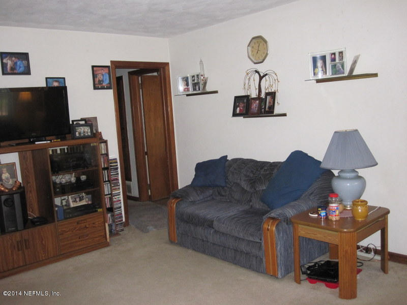 2618 Sam Road Jacksonville, FL 32216 - Photo 4 of 16 a living room with furniture and a flat screen tv