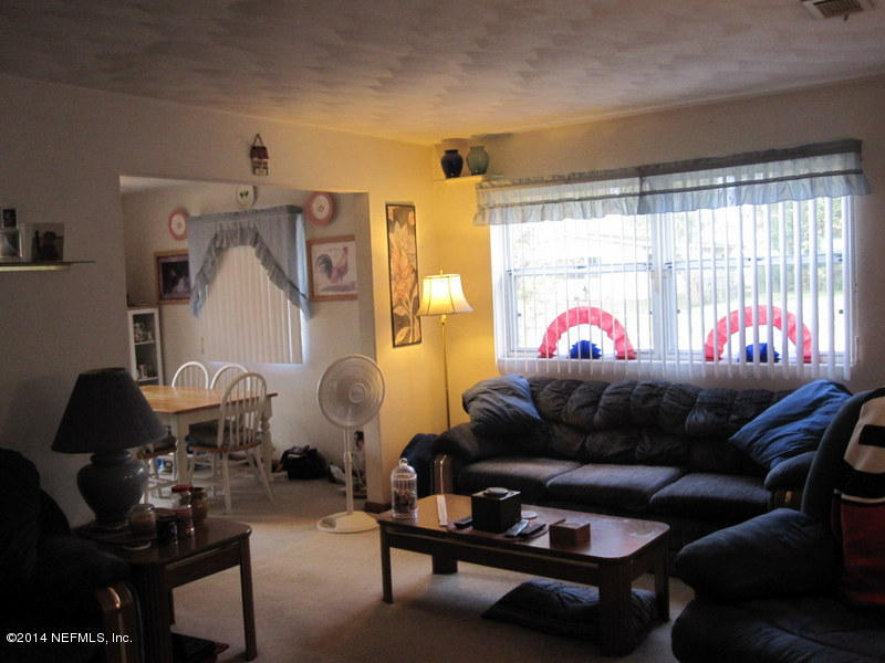 2618 Sam Road Jacksonville, FL 32216 - Photo 5 of 16 a living room with furniture and a window