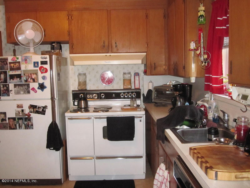 2618 Sam Road Jacksonville, FL 32216 - Photo 7 of 16 a kitchen with a stove and a refrigerator