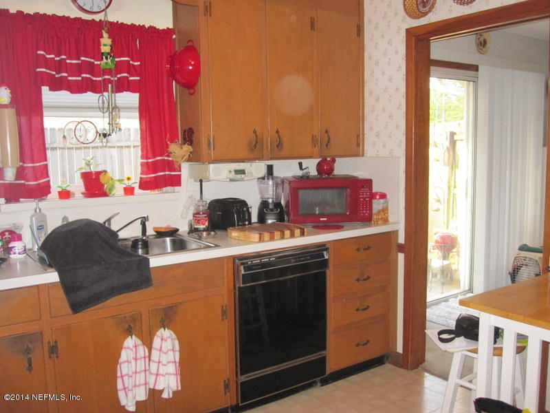 2618 Sam Road Jacksonville, FL 32216 - Photo 8 of 16 a kitchen with a sink stove and cabinets